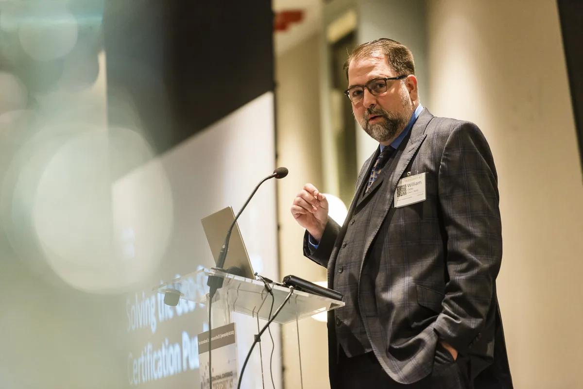 William Ochs speaking at a cybersecurity standards conference
